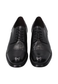 Zwarte leren oxford schoenen met een gepolijste afwerking. Voorzien van brogue-details, gesloten veters en een ronde neus.
