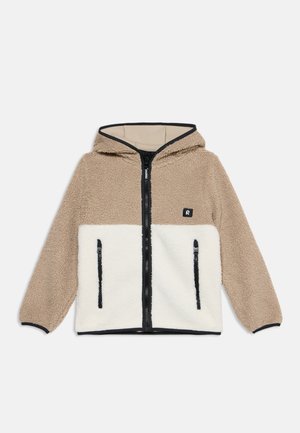 Veste polaire à capuche pour enfant avec partie supérieure beige et partie inférieure blanche, fermeture éclair noire et deux poches verticales zippées.