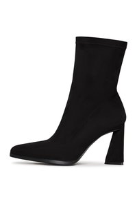 Black ankle boot made of soft fabric, featuring a pointed toe and a square high heel. Smooth texture with minimal stitching details.
