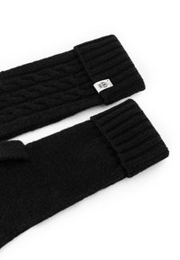 Black knitted gloves featuring a ribbed cuff and cable knit pattern, with a small branded label on one glove. Soft, warm fabric.