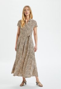 Beige ja ruskeat leopardsamettikuvioinen midimekko, jossa on lyhyet hihat ja vyötäröltä kiristettävä vyö. Kevyt kangas ja liehuva hame.