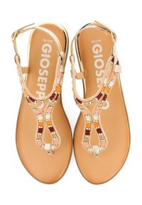 Sandalias de cuentas con hebilla en tono dorado y tiras beige. Patrón de cuentas colorido en naranja, blanco y marrón. Suela plana, soporte mínimo para el arco.