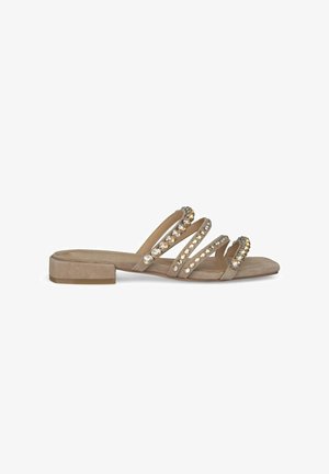 Sandales en daim beige avec trois lanières décoratives ornées de rhinestones clairs et dorés. Talon plat et design ouvert.