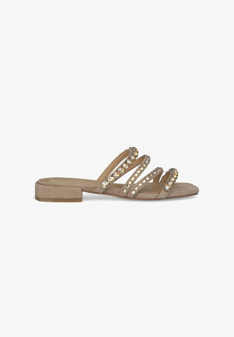 Beige suede sandals with three decorative straps featuring clear and gold rhinestones. Flat heel and open-toe design.