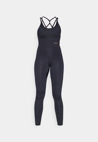 Aktivwear-setti mustana, jossa on ristikkäinen hihna-muotoilu ja korkea vyötärön leggingsit. Valmistettu joustavasta kankaasta, jolla on sileä rakenne.