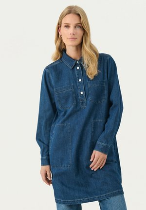 Denim shirt dress in dark blue, featuring a button-up collar, long sleeves, two front pockets, and a relaxed fit.