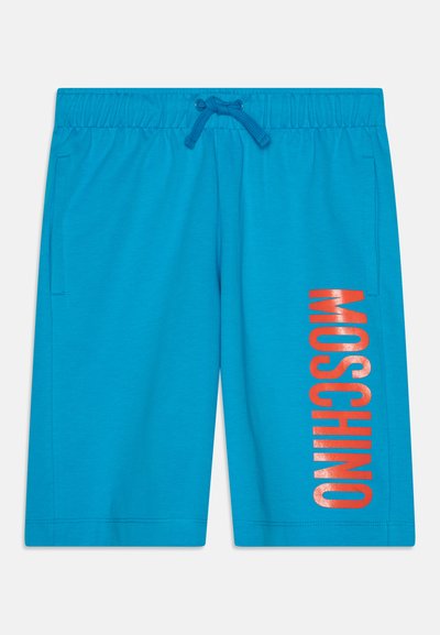 Turkizne hlače z elastičnim pasom in vrvico ter sijočim oranžnim napisom "MOSCHINO" ob strani. Mehka bombažna tkanina.