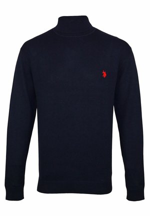 Laivastonsininen pitkähihainen pooloneule, jossa on resorit hihansuissa ja helmassa sekä pieni punainen kirjailtu logo vasemmassa rinnassa.