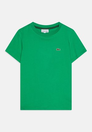 Grünes Baumwoll-T-Shirt mit Rundhalsausschnitt und kurzen Ärmeln. Verfügt über ein kleines Logo auf der Brust und eine glatte, gleichmäßige Textur.