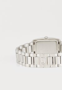 Silver metal wristwatch with a rectangular face and linked bracelet design. Smooth texture with a push-button clasp.