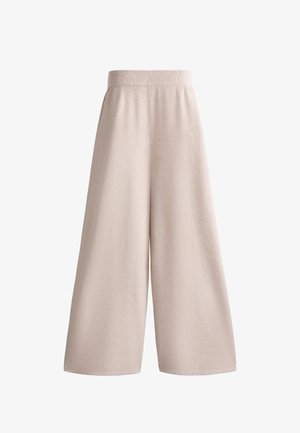 Beiga vida byxor gjorda av ett strukturert tyg, med ett elastiskt midjeband och lös passform, med en ren fåll och utan synlig hårdvara.