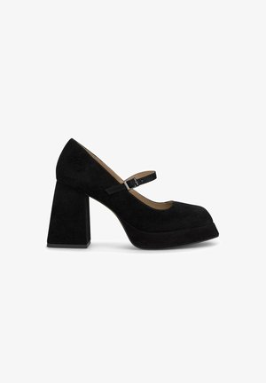 Black suede Mary Jane shoes with a rounded toe, adjustable strap, and a chunky block heel. Features a platform sole for added comfort.