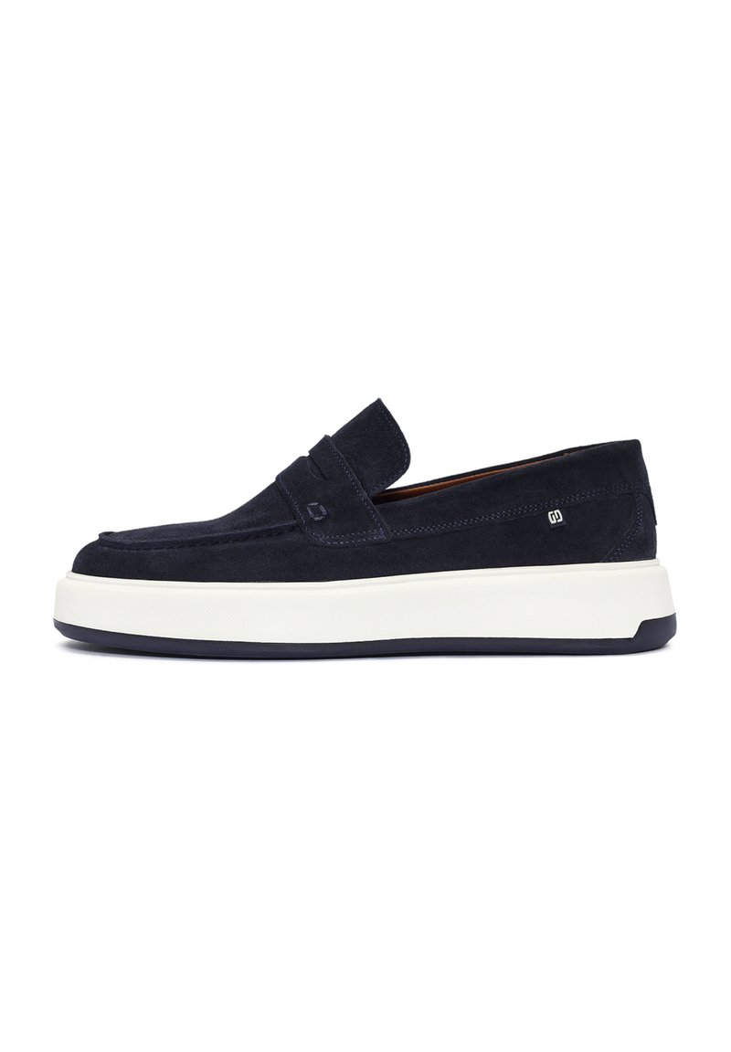 Zapatos slip-on de ante azul marino con suela de goma blanca, que presentan un detalle de costura en la parte delantera y un branding sutil en el lateral.