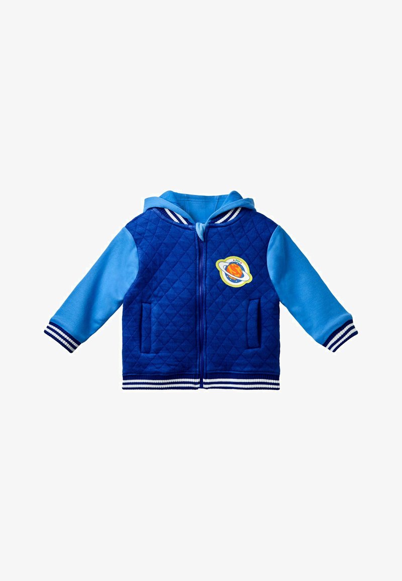 Kék steppelt kabát kék ujjal. Csíkozott ribb belső szegéllyel és mandzsettákkal, elülső zsebekkel, valamint egy kerek bolygó grafikával a mellkason.