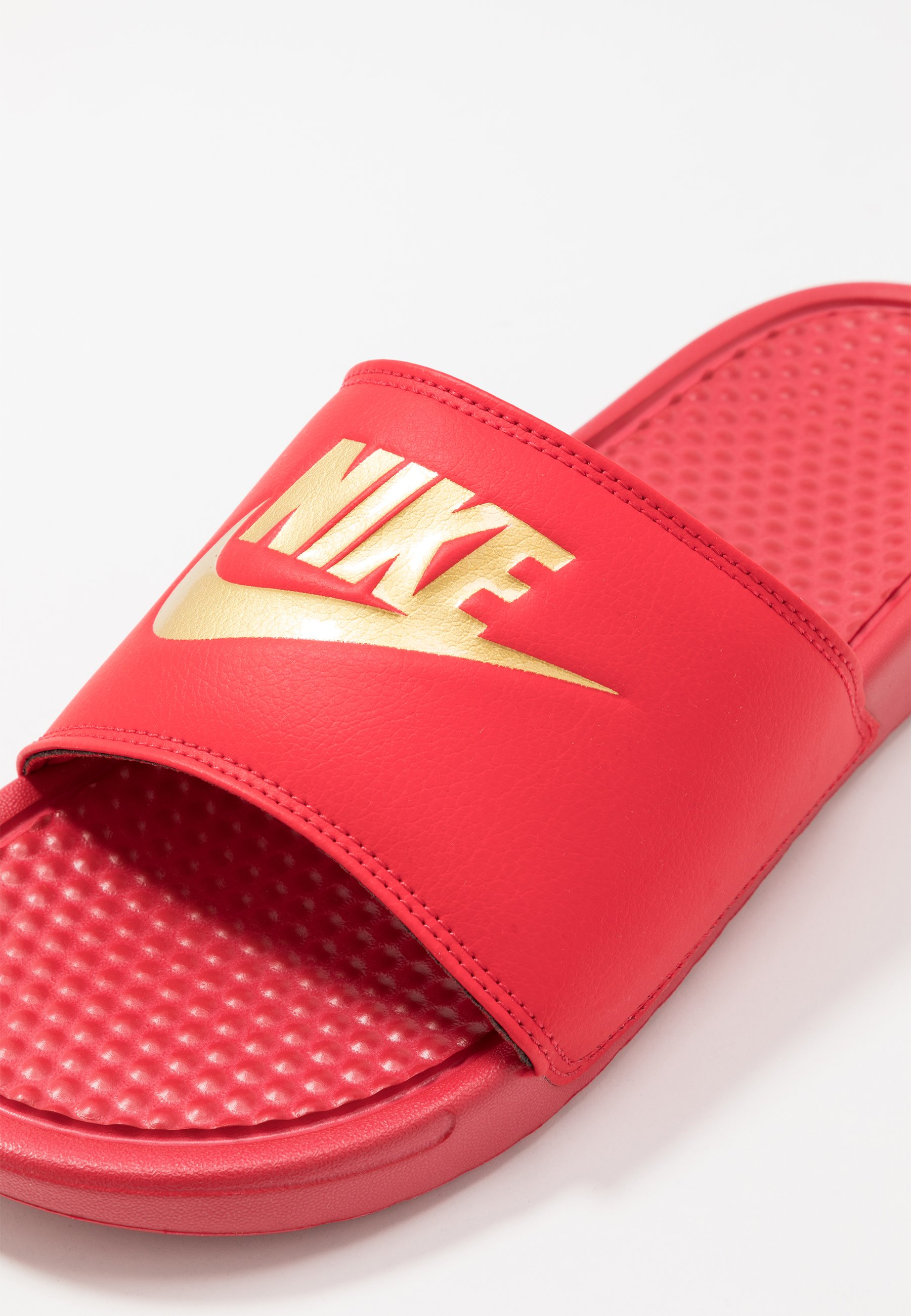 red and gold nike flip flops