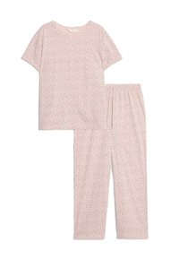 Conjunto de pijama de manga corta color rosa claro y pantalones largos con pequeños lunares negros y cinturilla elástica en los pantalones.