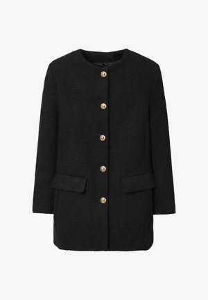 Cappotto nero con texture, presenta un colletto rotondo, chiusura frontale con bottoni dorati e due tasche anteriori. Forma sartoriale con maniche lunghe.