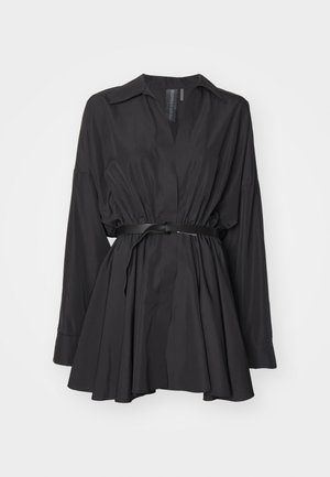 Black shirt dress made of a smooth fabric, featuring a v-neck, long sleeves, cinched waist with a belt, and flared skirt.