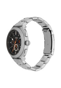 La montre Fossil pour homme présente un bracelet en acier inoxydable, un cadran noir et des accents orange. Le boîtier rond possède des nervures texturées et plusieurs sous-cadrans.