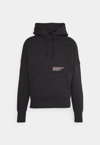 Felpa nera con cappuccio e tasca anteriore, realizzata in tessuto morbido. Presenta un logo testuale bianco: "Calvin Klein Jeans Established 1978 New York, NY."