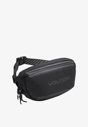 Sac à taille noir en tissu texturé. Il comprend une poche zippée à l'avant, une bandoulière réglable rayée et le logo Volcom sur le côté.