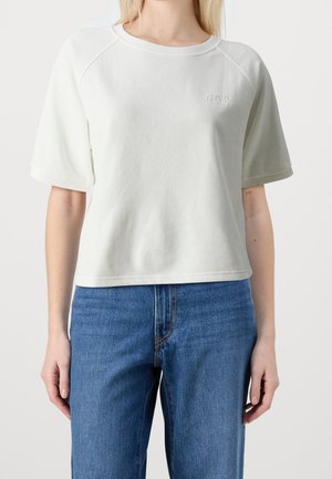 Jasnoszara, krótkozasięgowa bluza z okrągłym dekoltem, z małym, tłoczonym logo "GAP" z przodu i luźnym krojem.