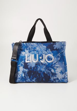 Sac cabas Liu Jo bleu à motif floral avec poignées noires et bandoulière noire amovible sur fond uni.