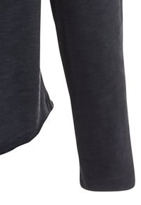 Donkergrijze lange mouwen shirt van zachte, gestructureerde stof. Heeft een ontspannen pasvorm en een eenvoudige, ronde halslijn.