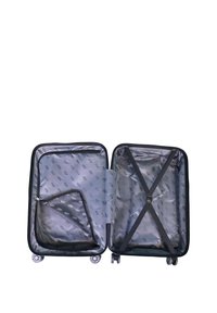 Hard-shell suitcase in black with a gray interior. Features cross straps, a zippered pocket, and four spinner wheels for mobility.