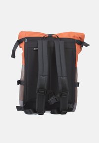 Rucksack mit orangefarbenem Deckel, schwarzem Körper und braunen Akzenten; aus strapazierfähigem Material gefertigt, mit verstellbaren Trägern und einem Obergriff.