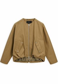 Veste zippée marron clair avec un col rond, une coupe oversize, deux poches avant et un ourlet froncé. Fabriquée en tissu léger.