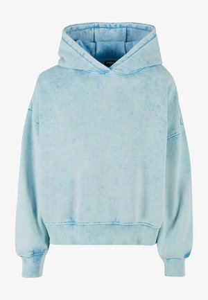 Svetlo modra, prevelika kapuca z teksturiranim zaključkom, opremljena sprednjim žepom, kapuco z elastičnim vrvico in rebrastimi manšetami ter robom.