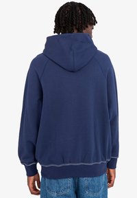 Navy blue hoodie with a spacious hood, ribbed cuffs, and hem. Made from soft fabric, featuring raglan sleeves and contrast stitching.