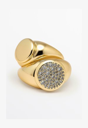 Gold-colored ring with a smooth, rounded band. Features a round, textured setting with multiple small, sparkling stones.