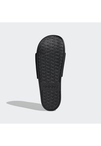 Black slide sandal featuring a textured rubber sole with a diamond pattern, and "adidas" embossed on the footbed for brand identification.