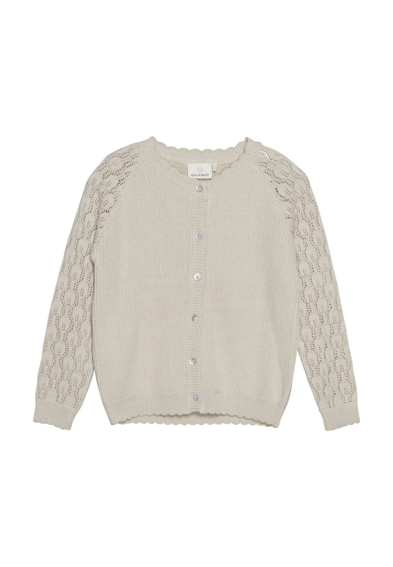 Ljus beige cardigan i stickad tyg. Har ärmar med spetsmönster, knappstängning och vågig nederkant.