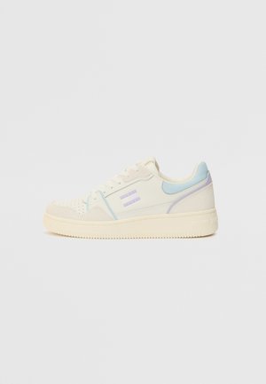 Low-top sneaker with a cream upper, light blue and lavender accents, textured suede overlays, and a rubber sole featuring horizontal grooves.