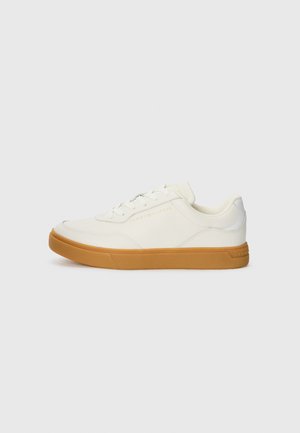 White leather sneaker with a gum rubber sole, rounded toe, lace-up front, and subtle brand logo on the side.