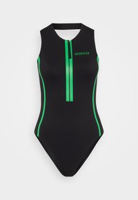 Maillot de bain une pièce noir avec des accents verts, présentant un col haut, une fermeture éclair centrale et des rayures horizontales sur les côtés.