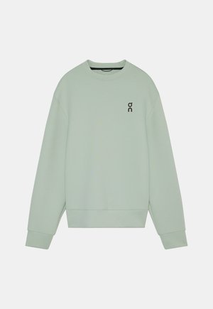 Sweat-shirt vert clair à manches longues avec col rond, poignets et ourlet côtelés, et un petit logo noir "on" sur la poitrine gauche.