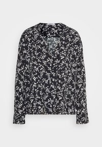 Svart langermet bluse med V-hals, med et hvitt blomsterdesign over hele. Laget av lett stoff med en avslappet passform.