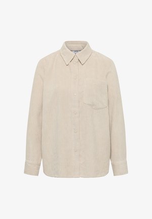 Camisa de pana beige con cuello, mangas largas, botones en el frente y un bolsillo en el pecho. Presenta una textura de canalé vertical.