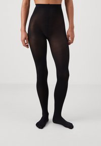 Black opaque tights with a high waistband, smooth texture, and a fitted shape, extending to the ankles. No patterns or detailing visible.