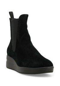 Stivaletto in suede nero con pannelli elastici ai lati, punta tonda e soletta spessa a zeppa per un'altezza e stabilità aggiuntive.