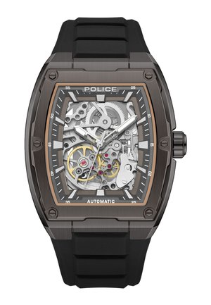 Reloj de pulsera automático para hombre con correa de goma negra, caja metálica rectangular y engranajes mecánicos visibles en plata y oro en la esfera.