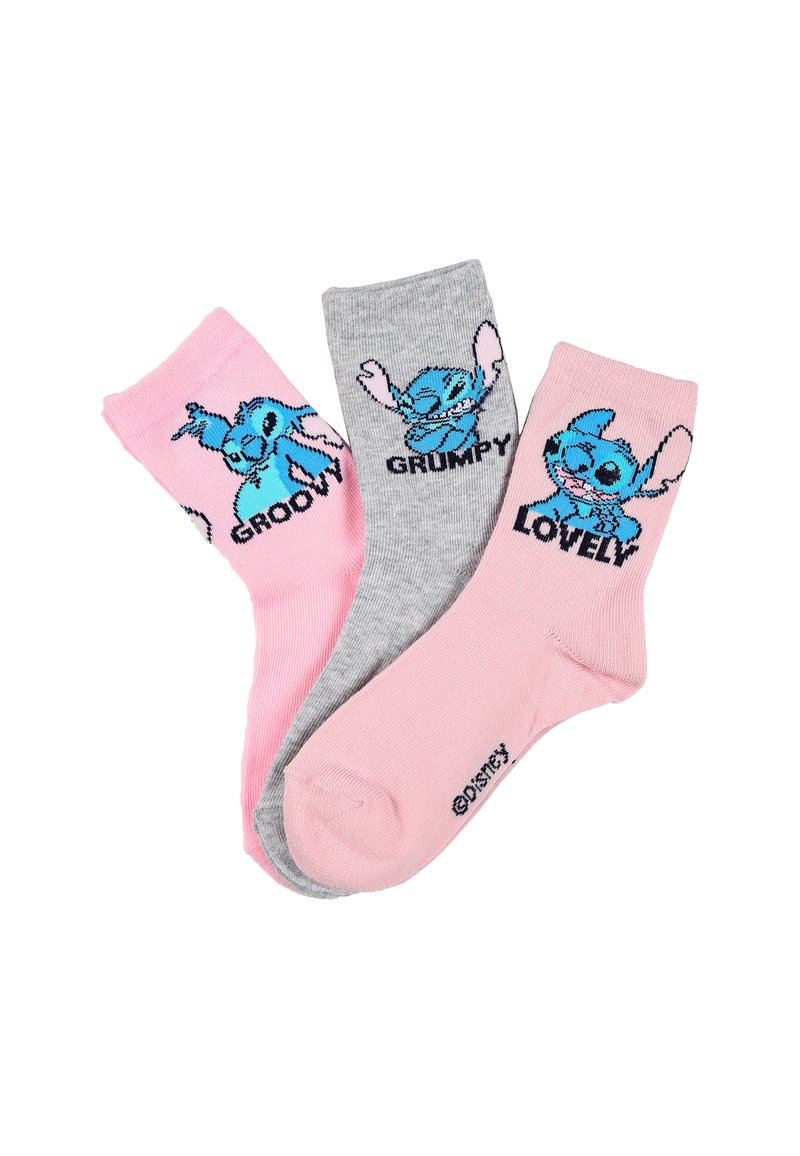 Tres pares de calcetines tobilleros: rosa con un personaje de dibujos animados azul etiquetado como "GROOVY", gris con "GRUMPY" y rosa con "LOVELY". Textura de punto.