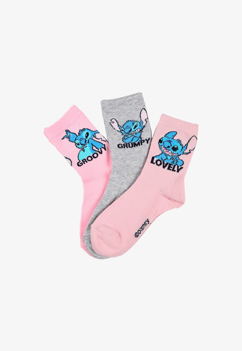 Tres pares de calcetines tobilleros: rosa con un personaje de dibujos animados azul etiquetado como "GROOVY", gris con "GRUMPY" y rosa con "LOVELY". Textura de punto.