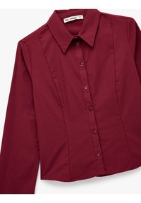 Burgundy long-sleeve button-up shirt with a pointed collar, featuring a fitted design and smooth texture. Five buttons along the front.