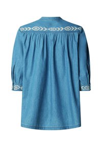 Blue denim long-sleeve shirt with white geometric embroidery on upper back and cuffs, featuring gathered fabric below the yoke.