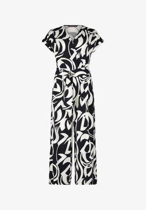 Czarny i biały kombinezon w wzory z kopertowym dekoltem, krótkimi rękawami, szerokimi nogawkami, wiązanym w pasie oraz dekoracyjnym akcentem w postaci klamry.